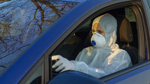 CLOSE UP: Female doctor wearing protective gear drives to coronavirus epicenter