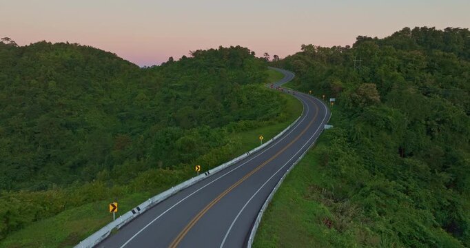 Aerial drone view of a picturesque mountain road shaped like the number three in Nan Province. This famous viewpoint attracts travelers and photographers seeking breathtaking curves and stunning