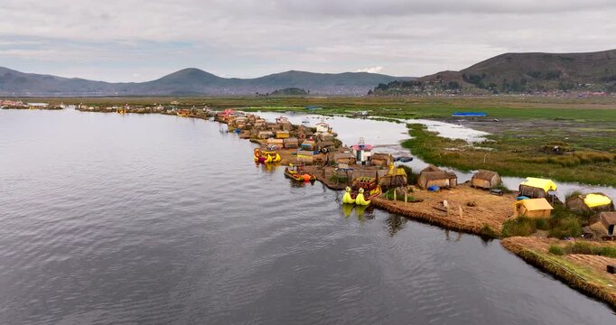 Uros Floating Islands on Lake Titicaca, Puno, Peru, showing reed homes, colorful totora rafts and traditional lake life on the high Andean plateau, aerial view