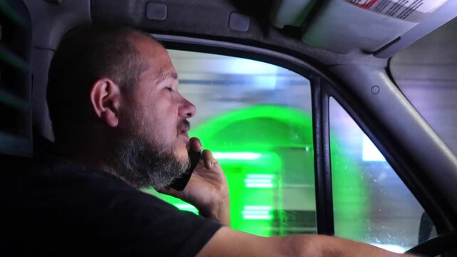 Delivery driver talks on the phone while driving a van, putting himself and others at risk. The scene highlights distraction and unsafe driving behavior.