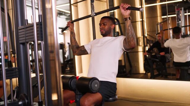 Tattooed african american man exercising at the gym
