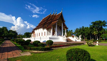 Obraz premium A serene white temple with a brown roof surrounded by greenery