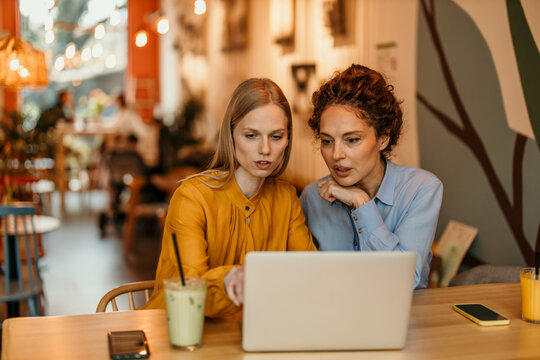 Professionals collaborating on laptop during business meeting
