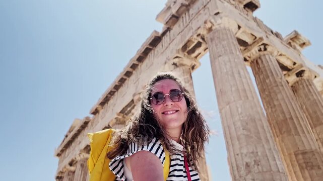 Woman admiring ancient parthenon columns in athens greece