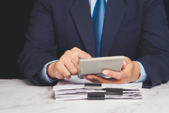 Business person using calculator for financial calculation