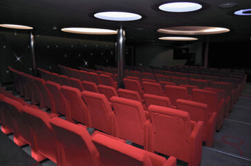 Small show entertainment lounge movie theatre onboard modern cruiseship cruise ship liner with dancefloor, movie screen, and plush armchairs seating in intimate elegant ambiance decor © Tamme Wichmann
