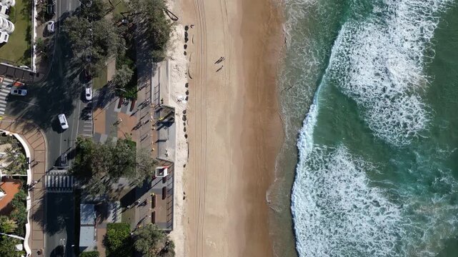 Aerial view of the beaches and promenade of Gold Coast Queensland Australia. Beautiful city landscape, waves of the Pacific Ocean, waterfront with high-rise buildings.