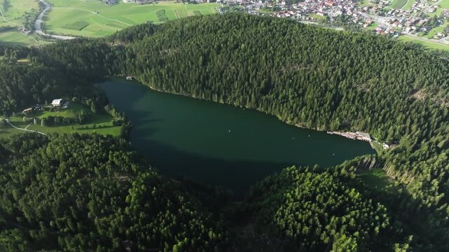 Aerial view of Piburger Lake landscape in Turol Austria. Alpine lake surrounded by forest on mountain slopes, nature of Europe.
