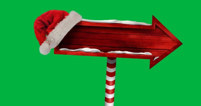 Digital animation of santa hat over red wooden sign post with copy space against black background