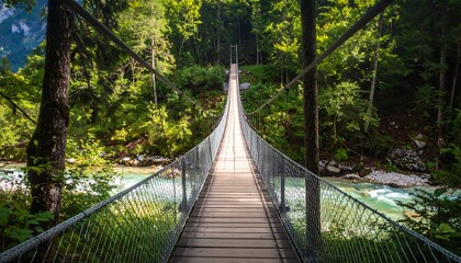 Fototapeta premium A serene suspension bridge over a river in a lush forest