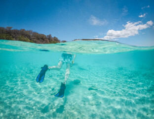 Split View of Snorkeler in Turquoise Caribbean Water Beneath Blue Sky © PatrickW