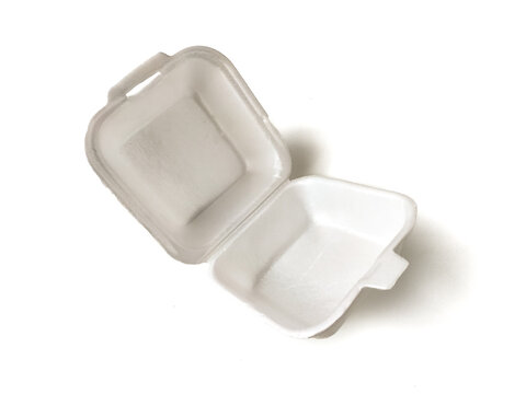 Open white styrofoam food container with a hinge. It's empty and features a simple rectangular shape with a textured surface. 