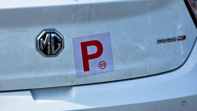 P Sign of learner Australia.White P 90 Plate sign at the back of a car showing that a probationary driver is behind the wheel