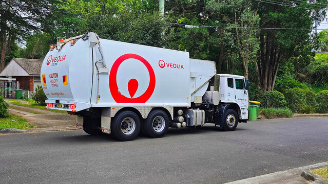 Veolia garbage truck collects waste on a quiet street in the morning in a residential area.Sydney Australia