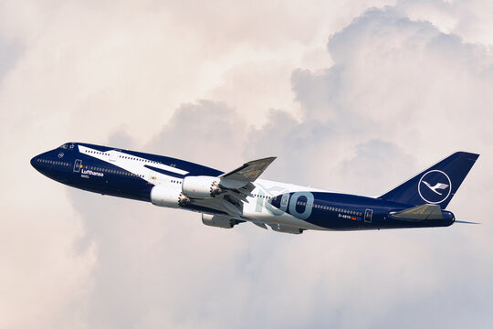 Lufthansa Boeing 747-8 (D-ABYN) passenger plane in special 100th anniversary livery taking off at Haneda Airport.