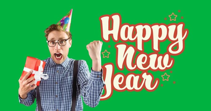 Portrait of caucasian man wearing party hat with gift box and happy new year text banner