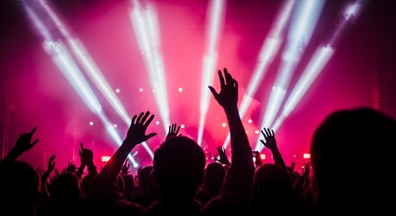 Energetic concert crowd silhouetted hands reach for the lights in a vibrant scene