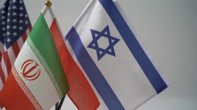 Three national flags stand side by side, United States, Iran, and Israel, symbolizing diplomacy, rivalry, and global tension, set against a backdrop of international affairs.
