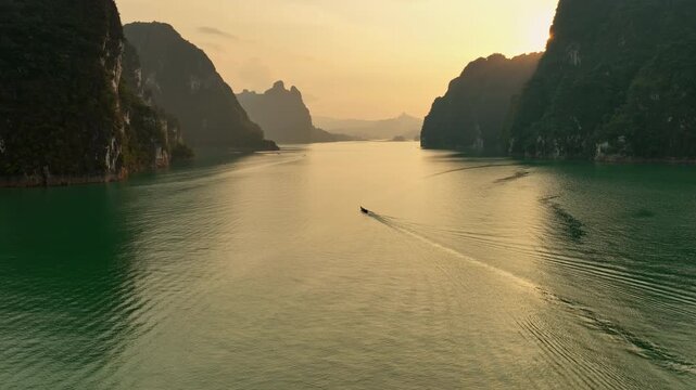Aerial view tracking boat in on the lake of Khao Sok national park
