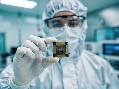 Scientist in cleanroom hold microchip, technology innovation, future device