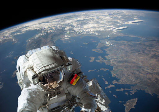 German astronaut in outer space during a spacewalk with planet Earth in the background. Elements of this image furnished by NASA.