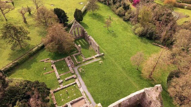 4K 60FPS aerial reveal video GV of Greyabbey Monastery Ruins in Greyabbey, County Down in Northern Ireland. Produced in 3840x2160 and with Rec709 color.