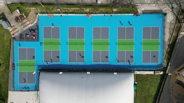 Timelapse Aerial View of Pickleball Games on Outdoor Blue Courts