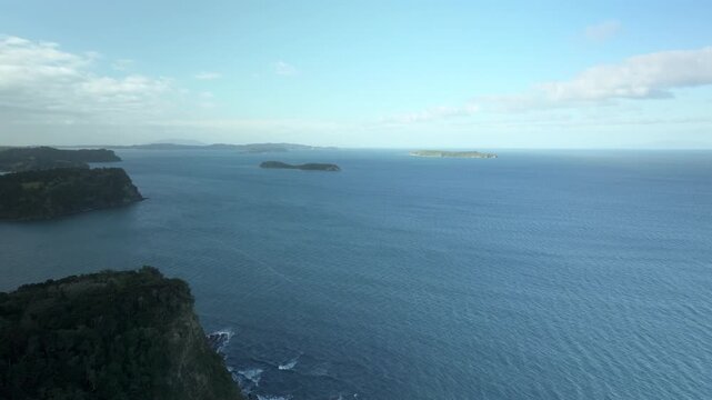 Overhead Flight Cliff, Sea, and Tiny Islands