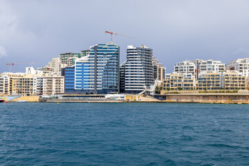 Sliema Modern Waterfront Skyline with Luxury High Rise Apartments and Construction Crane across Harbour Malta © Evgenii Peshkov