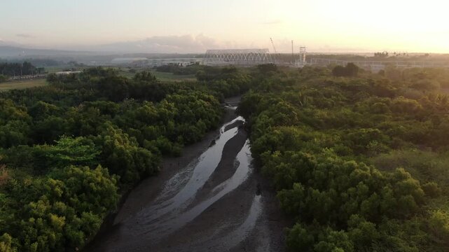 river delta along the narrow, white sandy beach of a rural town.  Drone, aerial