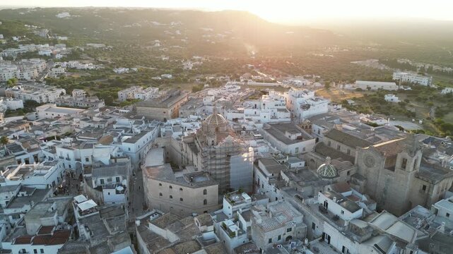Aerial footage of the city of Ostuni, or the White City, illuminated at the golden hour. Drone photo taken on 23rd of June 2025, Brindisi province, region of Apulia, Italy.