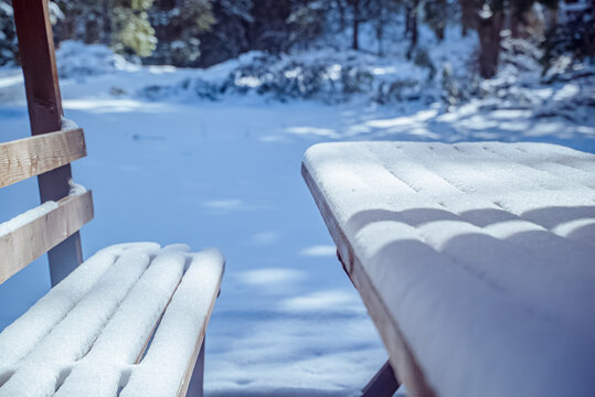 Șimon, Bucegi Mountains, Romania: Snow covered wooden bench and table in forest