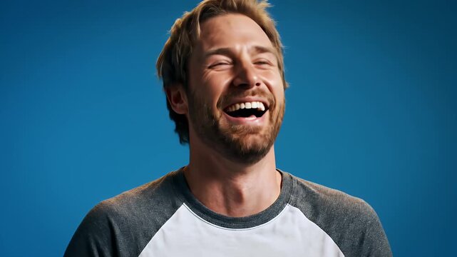 Man laughing hysterically with eyes closed, expressing pure joy and amusement.