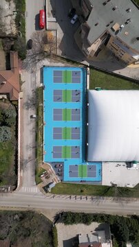 Top Down Aerial View of People Playing Pickleball on Blue Courts