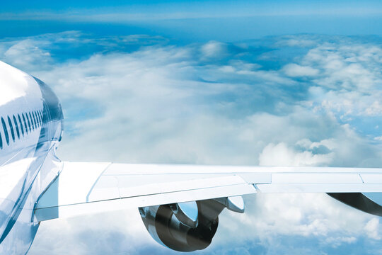 Passenger plane flight above clouds. Airplane wing rear view with empty space mockup