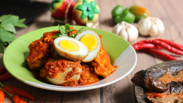 Bali telur, a classic Indonesian side dish of hard-boiled eggs and tofu in a rich spicy sauce, is often enjoyed with steamed white rice.