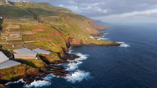 Aerial View of La Fajana Lighthouse and Coastal Banana Plantations at Sunrise; Maritime Infrastructure, Industrial Agriculture, and Solar Azimuth, La Palma, Canary Islands, Spain