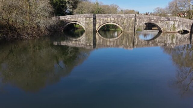 Historical Stone Bridge Over The Xallas River - Brandomil Roman Bridge In Zas, Galicia, Spain. Aerial Zoom In Shot