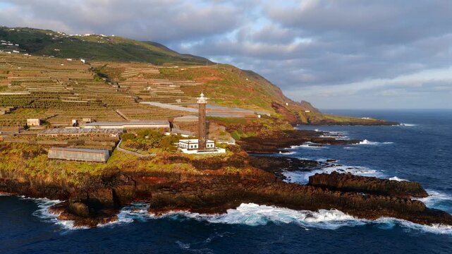 Aerial View of La Fajana Lighthouse and Coastal Banana Plantations at Sunrise; Maritime Infrastructure, Industrial Agriculture, and Solar Azimuth, La Palma, Canary Islands, Spain