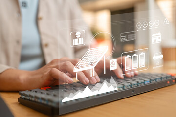 Hands typing with solar energy interface showing panel, battery storage, and smart grid monitoring, representing renewable energy management and sustainable technology solutions © Woonsen