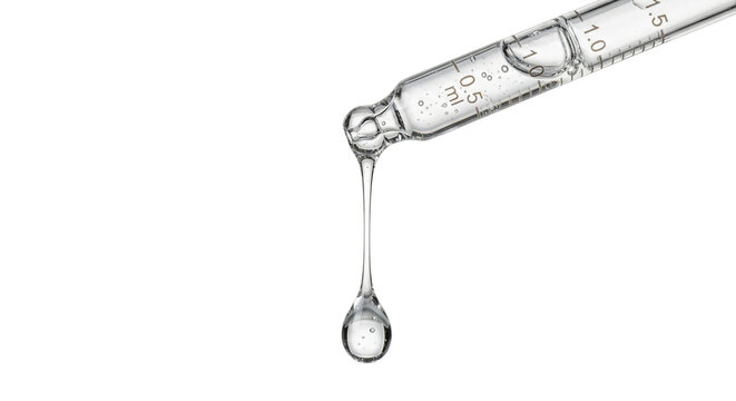 Glass pipette dropping clear liquid on black background
