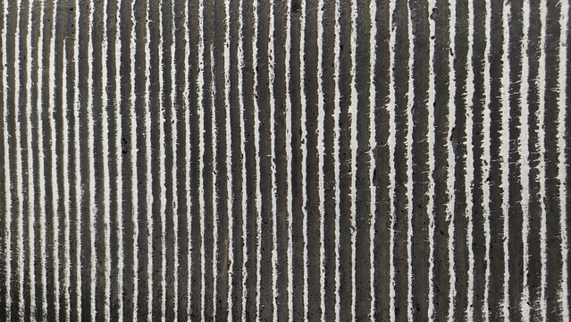 Black grey cemented lines texture in a dark background