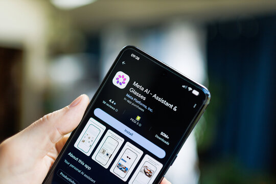 mobile phone in hand with Meta AI Assistant and Glasses app on the google play store