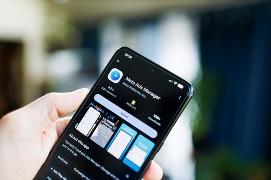 mobile phone in hand with Meta Ads Manager app on the google play store