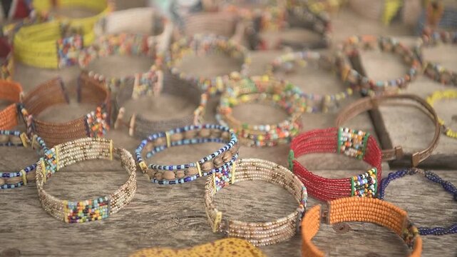 Vibrant traditional African beadwork bracelets showcased on a table for tourists and shoppers