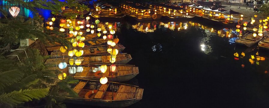 Floating lanterns on river at night in Ninh Binh Vietnam, glowing lights and scenic waterfront