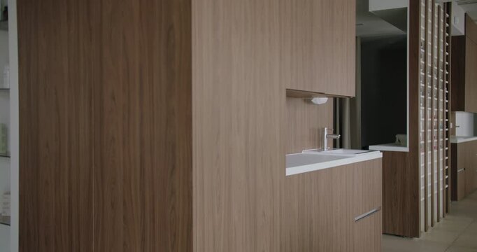 Explore the elegance of modern architecture with this stylish bathroom vanity area embellished by wooden accents and streamlined design. Modern Interior Design