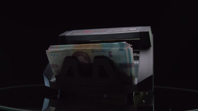 Money counting machine with Ukrainian hryvnia