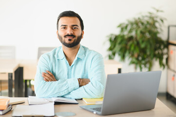 Fototapeta premium Young indian man studying learning with laptop
