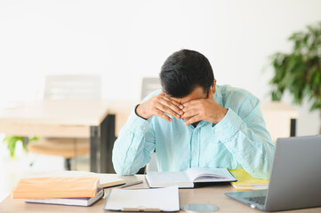 Fototapeta premium Indian student feeling stressed tired from studying and work